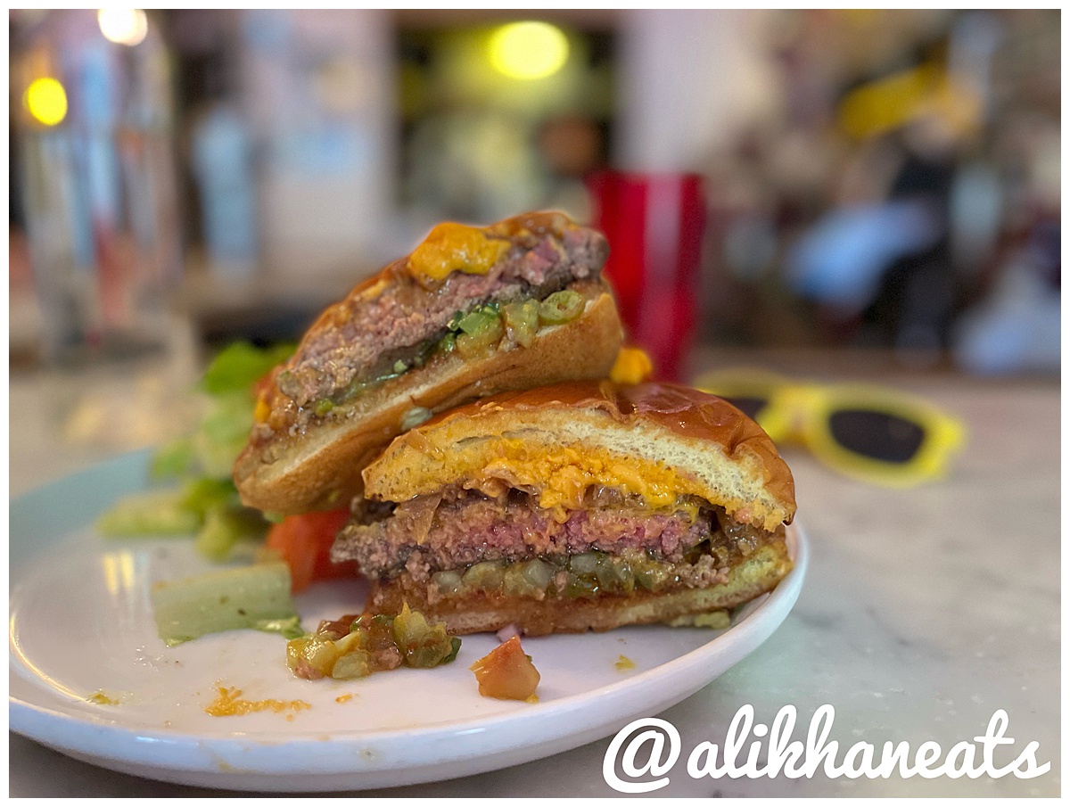 Emmett's NYC Char Cheddar Burger cut in half